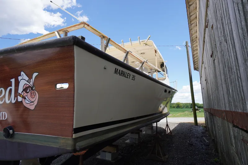 Slide: The Image of 1989 Markley 35 Ft. Deadrise boat on stands beside a wooden building. - 79