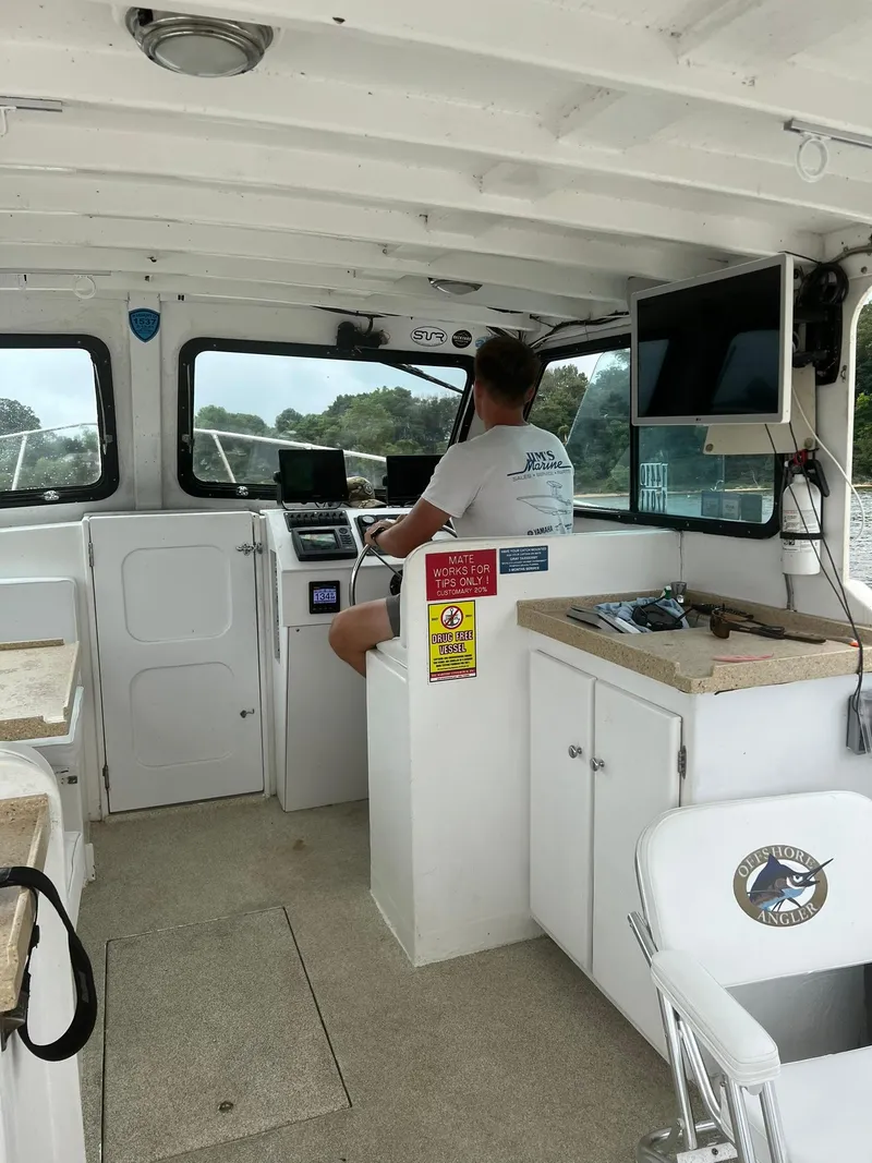 Slide: The Image of Interior of a 1998 Markley 35 Ft. Deadrise boat with a person at the helm. - 8