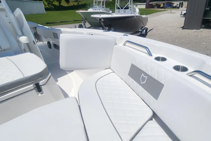 Slide: The Image of 2025 Sea Fox 268 Commander boat interior with white cushioned seating and cup holders. - 5
