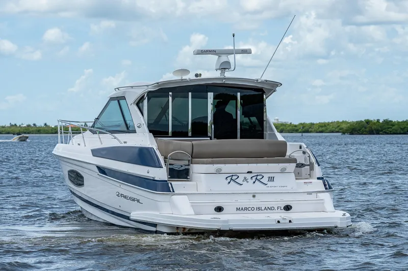 Slide: The Image of 2015 Regal 46 Sport Coupe yacht cruising on water. - 10