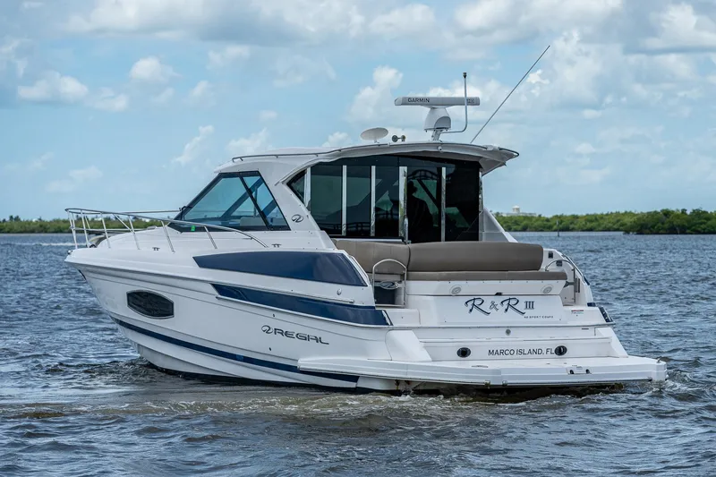 Slide: The Image of 2015 Regal 46 Sport Coupe yacht cruising on a calm lake. - 11