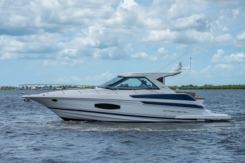 Slide: The Image of 2015 Regal 46 Sport Coupe yacht cruising on open water. - 15