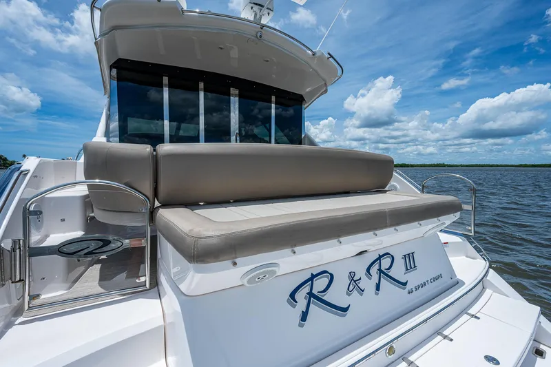 Slide: The Image of 2015 Regal 46 Sport Coupe yacht with rear seating on a sunny day. - 18