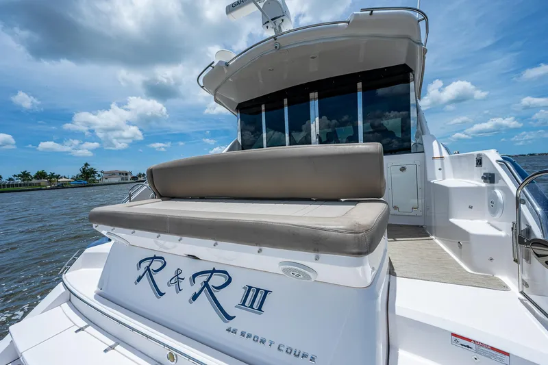 Slide: The Image of 2015 Regal 46 Sport Coupe yacht with rear seating on a sunny day. - 20