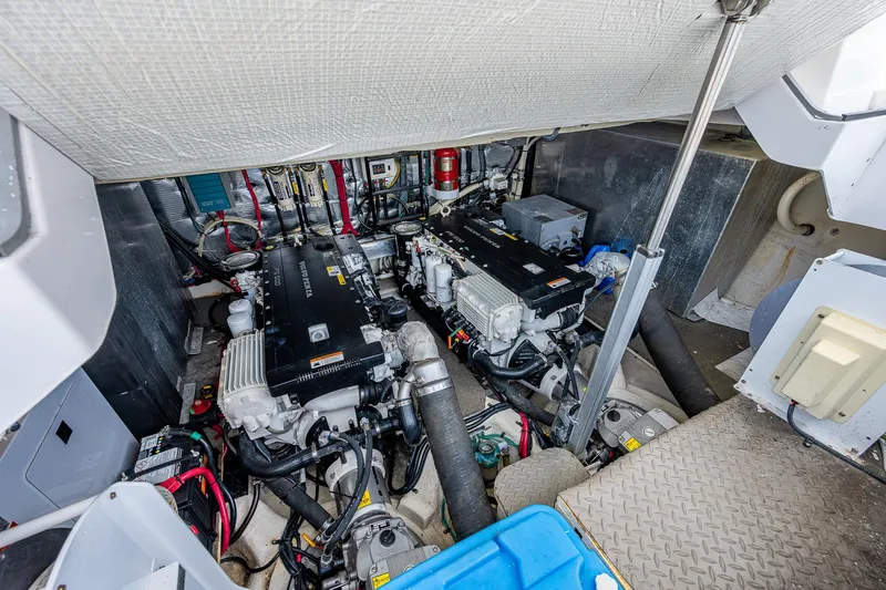 Slide: The Image of 2015 Regal 46 Sport Coupe engine room with twin engines and mechanical components. - 24