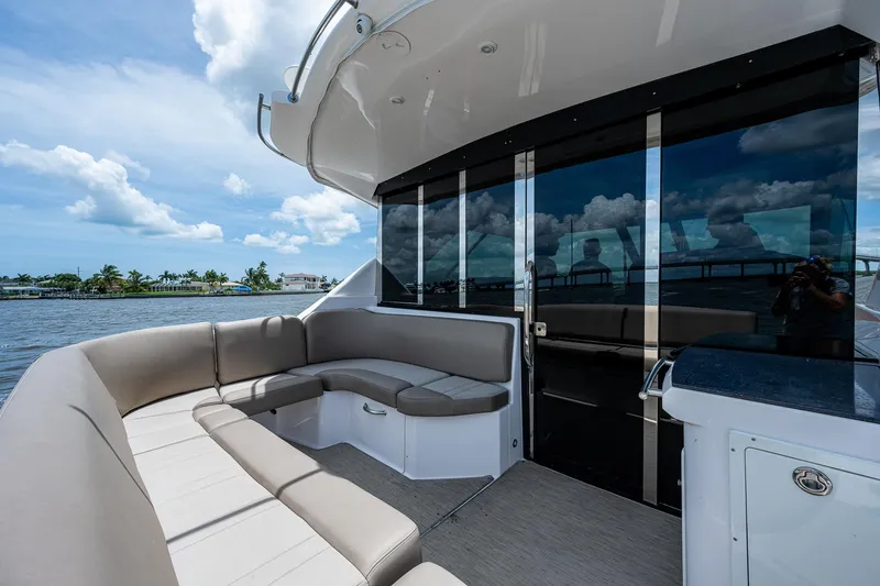 Slide: The Image of 2015 Regal 46 Sport Coupe yacht with spacious outdoor seating area. - 25