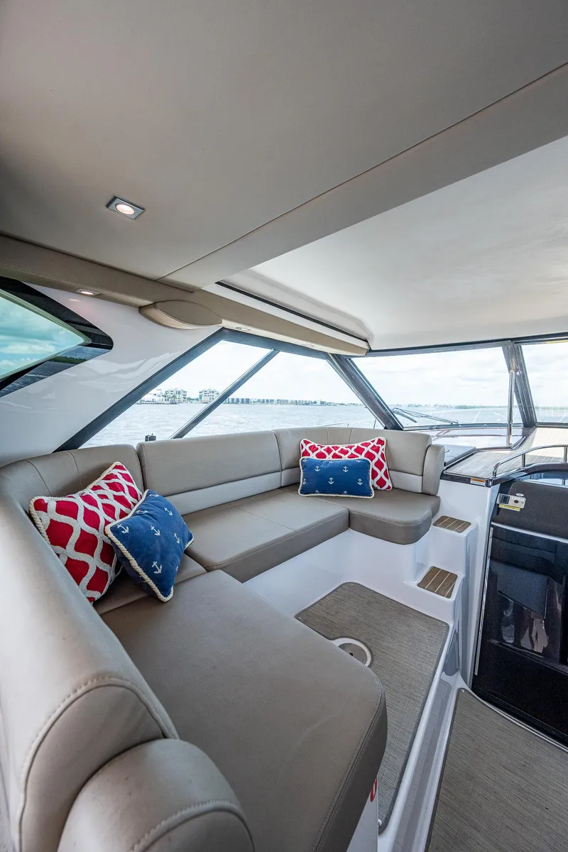 Slide: The Image of Interior of 2015 Regal 46 Sport Coupe with plush seating and decorative pillows. - 30