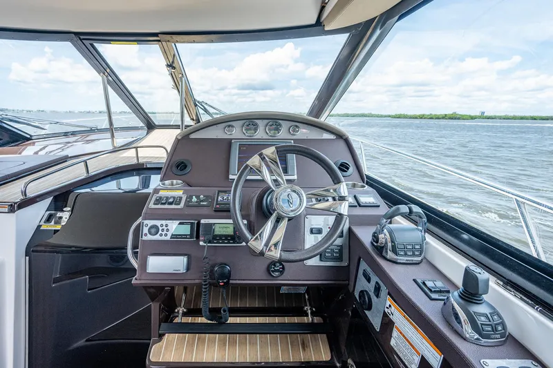 Slide: The Image of Cockpit of 2015 Regal 46 Sport Coupe yacht with advanced navigation controls. - 33