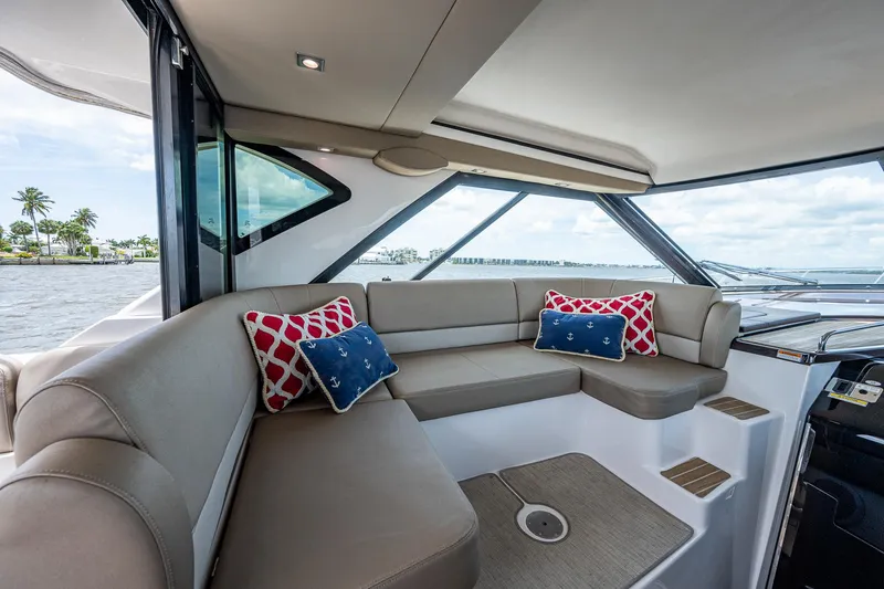 Slide: The Image of Luxurious interior of 2015 Regal 46 Sport Coupe yacht with plush seating and decorative pillows. - 35