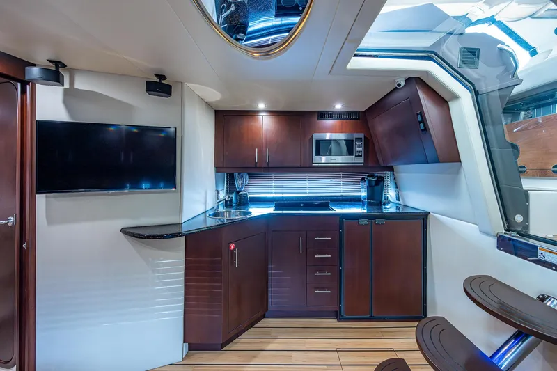 Slide: The Image of Luxurious interior of 2015 Regal 46 Sport Coupe with modern kitchen amenities. - 37