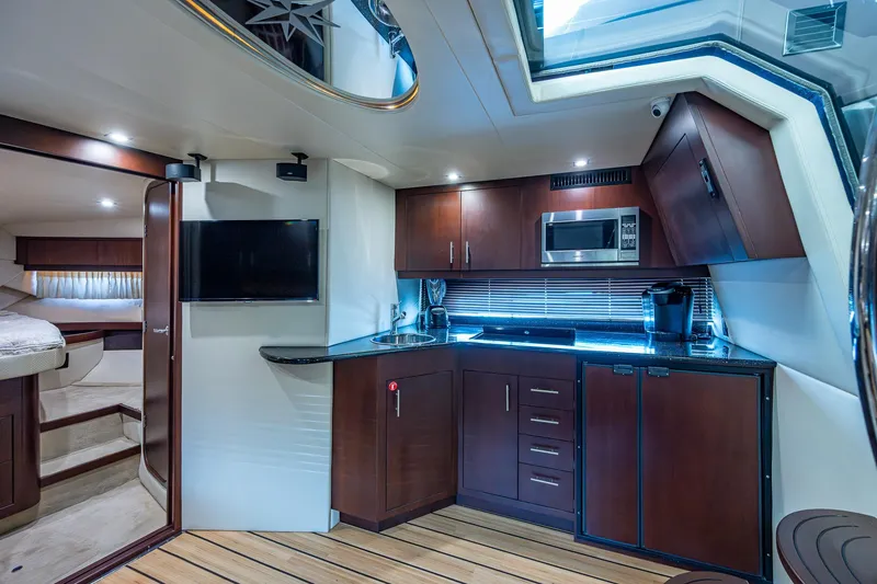 Slide: The Image of Interior of 2015 Regal 46 Sport Coupe yacht with modern kitchen and cozy bedroom. - 38