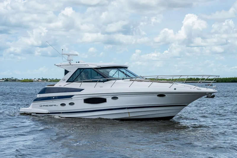 Slide: The Image of 2015 Regal 46 Sport Coupe yacht cruising on open water. - 4