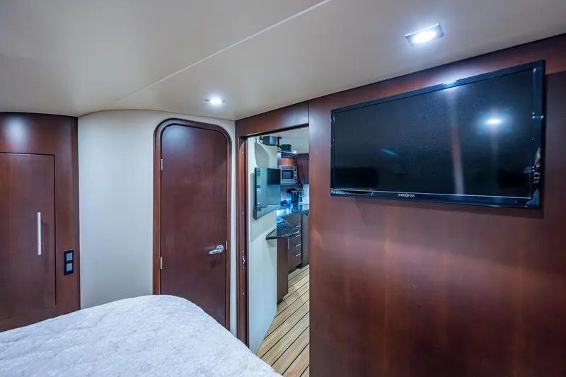 Slide: The Image of Interior of 2015 Regal 46 Sport Coupe with TV and wooden finishes. - 47