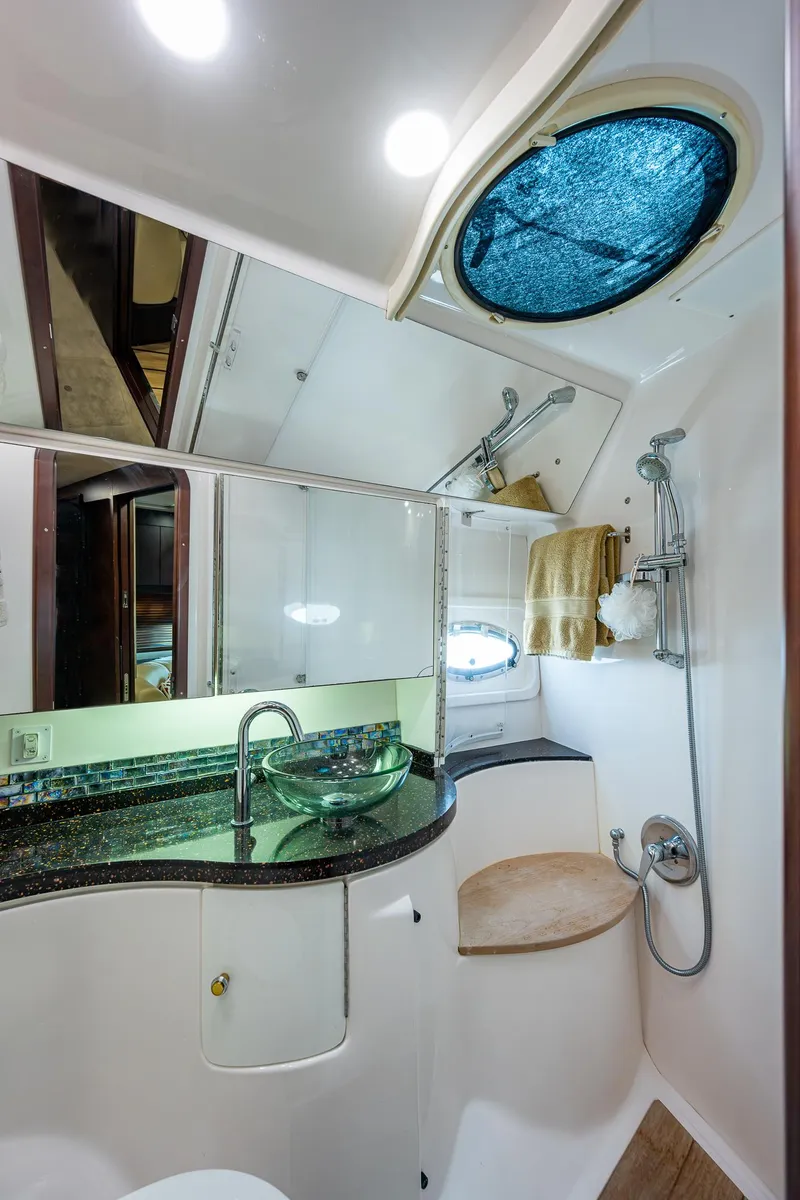 Slide: The Image of 2015 Regal 46 Sport Coupe bathroom with modern fixtures and porthole window. - 49