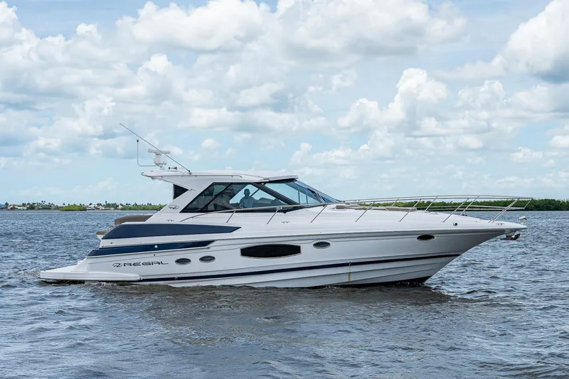 Slide: The Image of 2015 Regal 46 Sport Coupe yacht cruising on open water. - 5