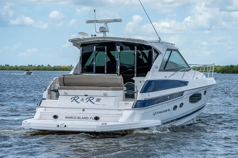 Slide: The Image of 2015 Regal 46 Sport Coupe yacht cruising on water near Marco Island, FL. - 8