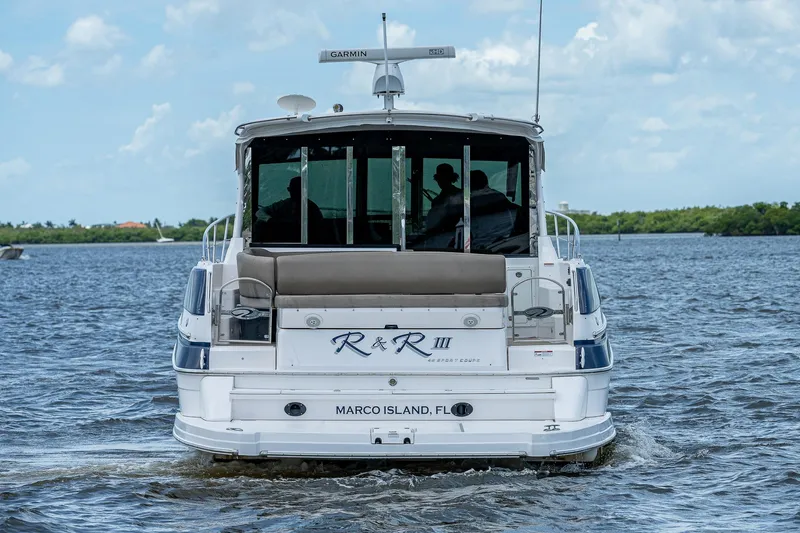 Slide: The Image of 2015 Regal 46 Sport Coupe yacht cruising on water near Marco Island, FL. - 9
