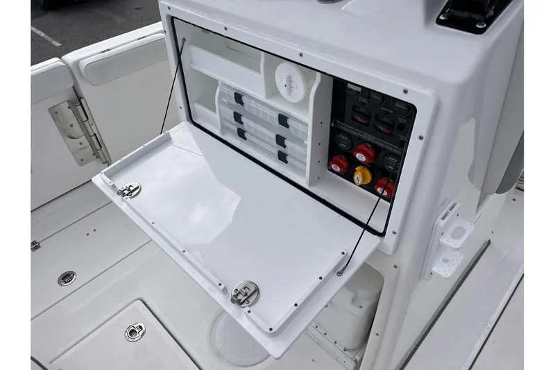 Slide: The Image of 2025 Sea Fox 288 Commander boat control panel with open storage compartment. - 11