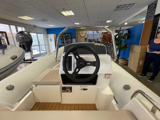 Slide: The Image of 2024 Northstar Axis 4.2 boat interior with steering wheel in showroom. - 5