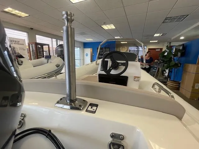 Slide: The Image of 2024 Northstar Axis 4.2 boat interior with steering wheel in showroom setting. - 6
