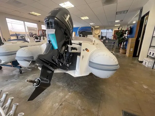 Slide: The Image of 2024 Northstar Axis 4.2 inflatable boat with outboard motor in showroom. - 8