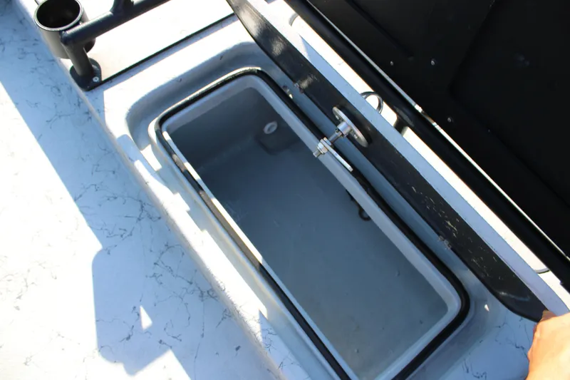 Slide: The Image of Open storage compartment on 2025 Mamba 23 Cat Classic boat deck. - 13