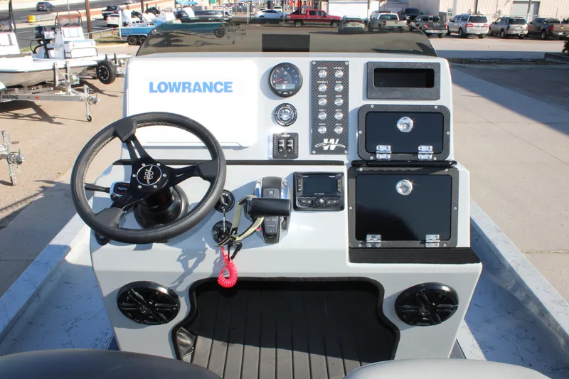 Slide: The Image of 2025 Mamba 23 Cat Classic boat dashboard with steering wheel and control panel. - 16