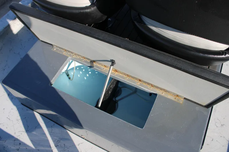 Slide: The Image of Open storage compartment in 2025 Mamba 23 Cat Classic boat interior. - 18
