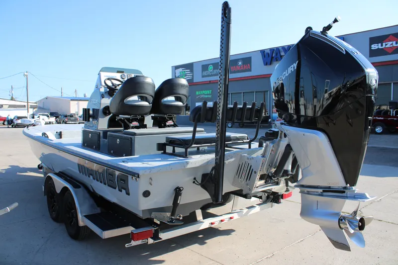 Slide: The Image of 2025 Mamba 23 Cat Classic boat with Mercury engine, parked outside dealership. - 7