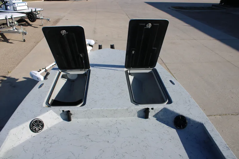 Slide: The Image of 2025 Mamba 23 Cat Classic boat deck with open storage compartments. - 8