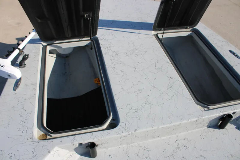 Slide: The Image of Open storage compartments on a 2025 Mamba 23 Cat Classic boat deck. - 9