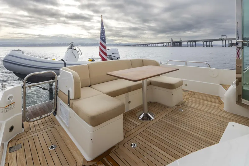 Slide: The Image of 2018 Sabre 45 Salon Express yacht deck with seating, table, and ocean view. - 11