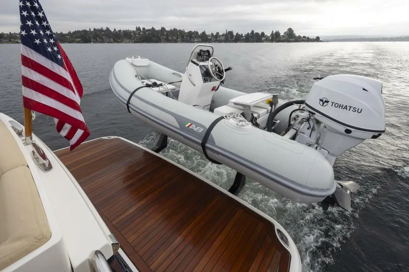 Slide: The Image of Sabre 45 Salon Express 2018 with dinghy and Tohatsu motor on water. - 12