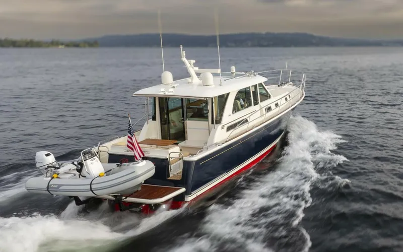 Slide: The Image of 2018 Sabre 45 Salon Express yacht cruising on open water, rear view. - 3
