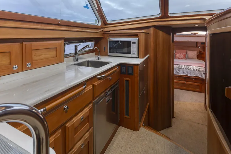 Slide: The Image of Interior of 2018 Sabre 45 Salon Express yacht, featuring a modern kitchen and cozy bedroom. - 36