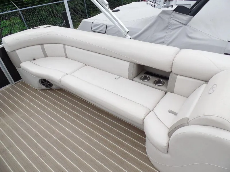 Slide: The Image of 2018 Harris Cruiser 240 boat interior with beige seating and cup holders. - 9