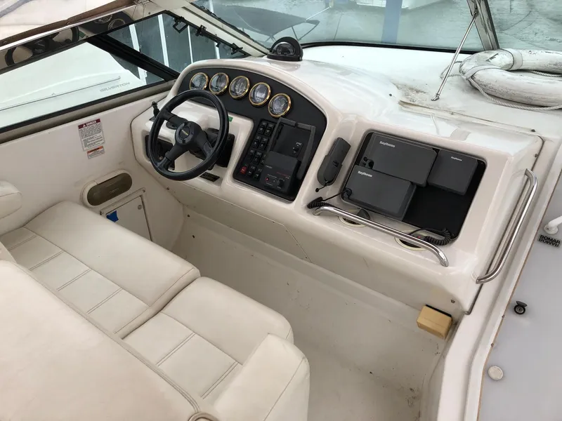 Slide: The Image of 1998 Carver 530 Voyager Pilothouse helm station with steering wheel and navigation instruments. - 16