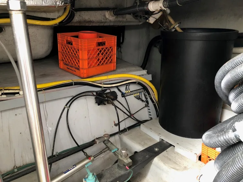 Slide: The Image of Engine room of a 1998 Carver 530 Voyager Pilothouse with wiring and storage. - 22