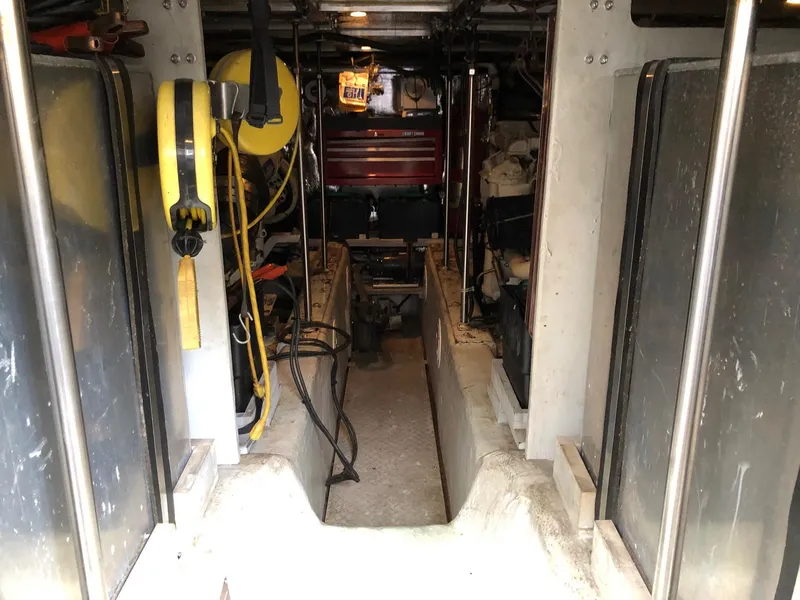 Slide: The Image of 1998 Carver 530 Voyager Pilothouse engine room with equipment and wiring. - 23