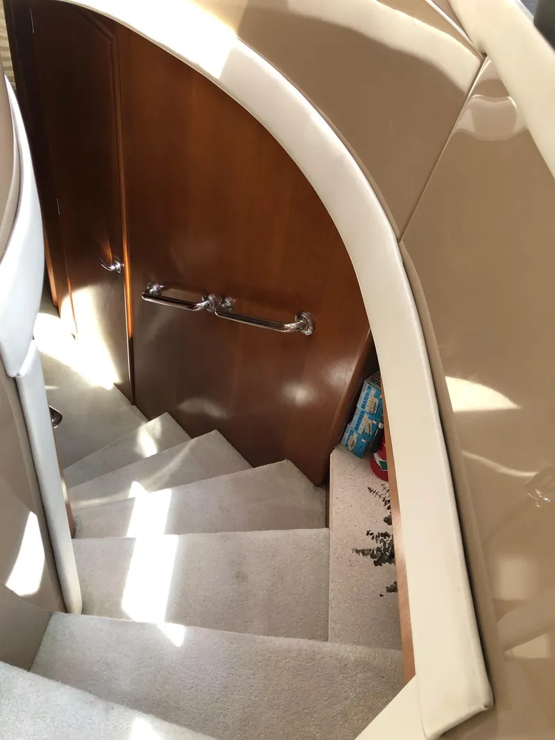 Slide: The Image of Staircase inside 1998 Carver 530 Voyager Pilothouse yacht with wooden door. - 34
