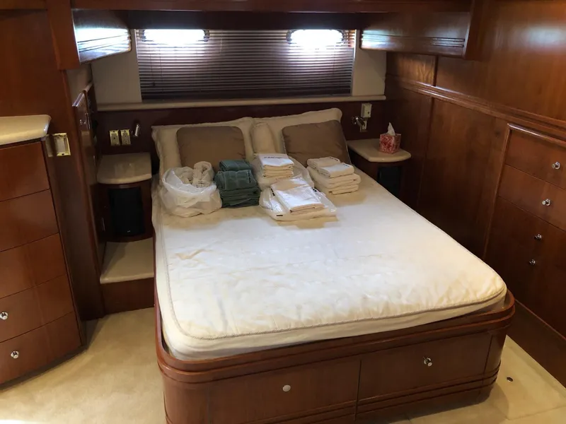 Slide: The Image of Luxurious bedroom in 1998 Carver 530 Voyager Pilothouse yacht with neatly folded linens. - 35
