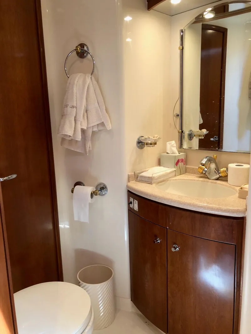 Slide: The Image of 1998 Carver 530 Voyager Pilothouse bathroom with wooden cabinetry and modern fixtures. - 43