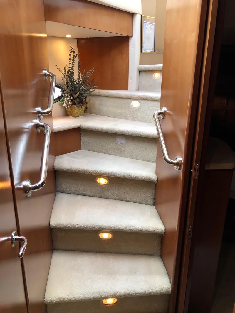Slide: The Image of Staircase inside 1998 Carver 530 Voyager Pilothouse yacht with carpet and handrails. - 46