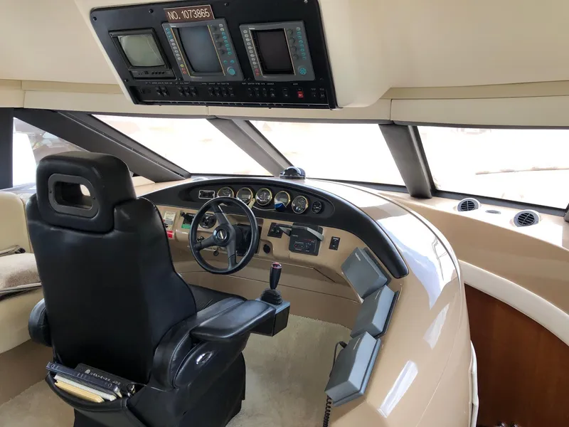 Slide: The Image of 1998 Carver 530 Voyager Pilothouse helm with navigation instruments and captain's chair. - 47