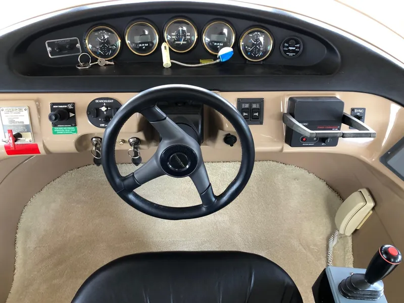 Slide: The Image of 1998 Carver 530 Voyager Pilothouse helm with steering wheel and instrument panel. - 49
