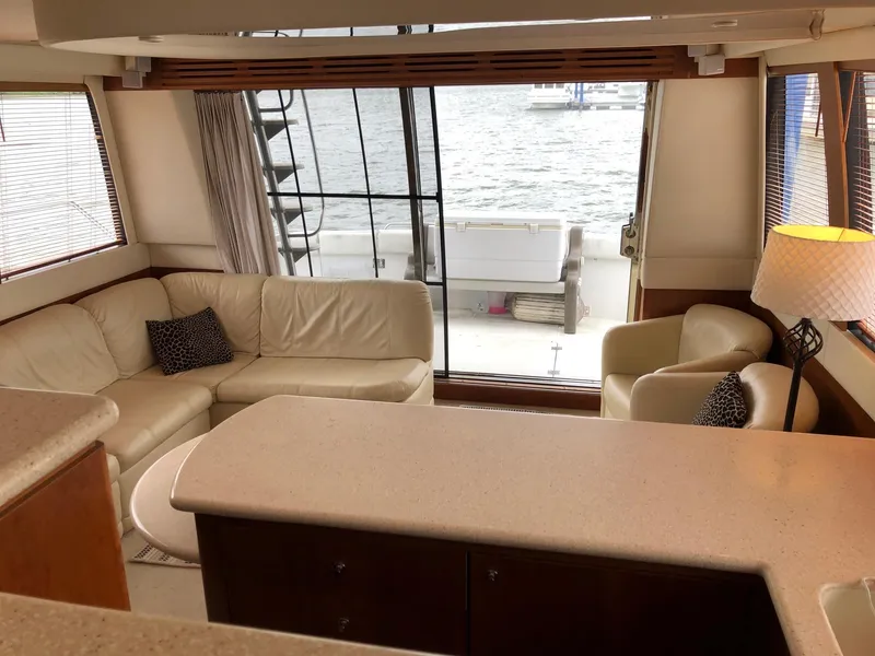 Slide: The Image of Interior of 1998 Carver 530 Voyager Pilothouse with leather seating and waterfront view. - 14