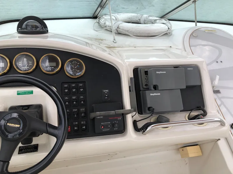 Slide: The Image of 1998 Carver 530 Voyager Pilothouse helm with steering wheel, gauges, and navigation equipment. - 18