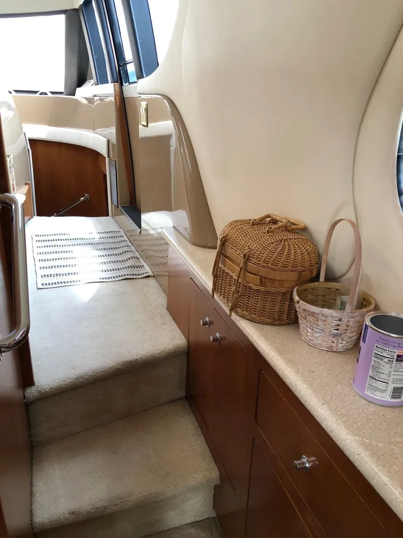 Slide: The Image of Interior of 1998 Carver 530 Voyager Pilothouse with stairs and storage baskets. - 33