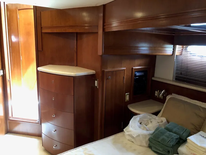 Slide: The Image of 1998 Carver 530 Voyager Pilothouse bedroom with wooden cabinetry and natural light. - 36