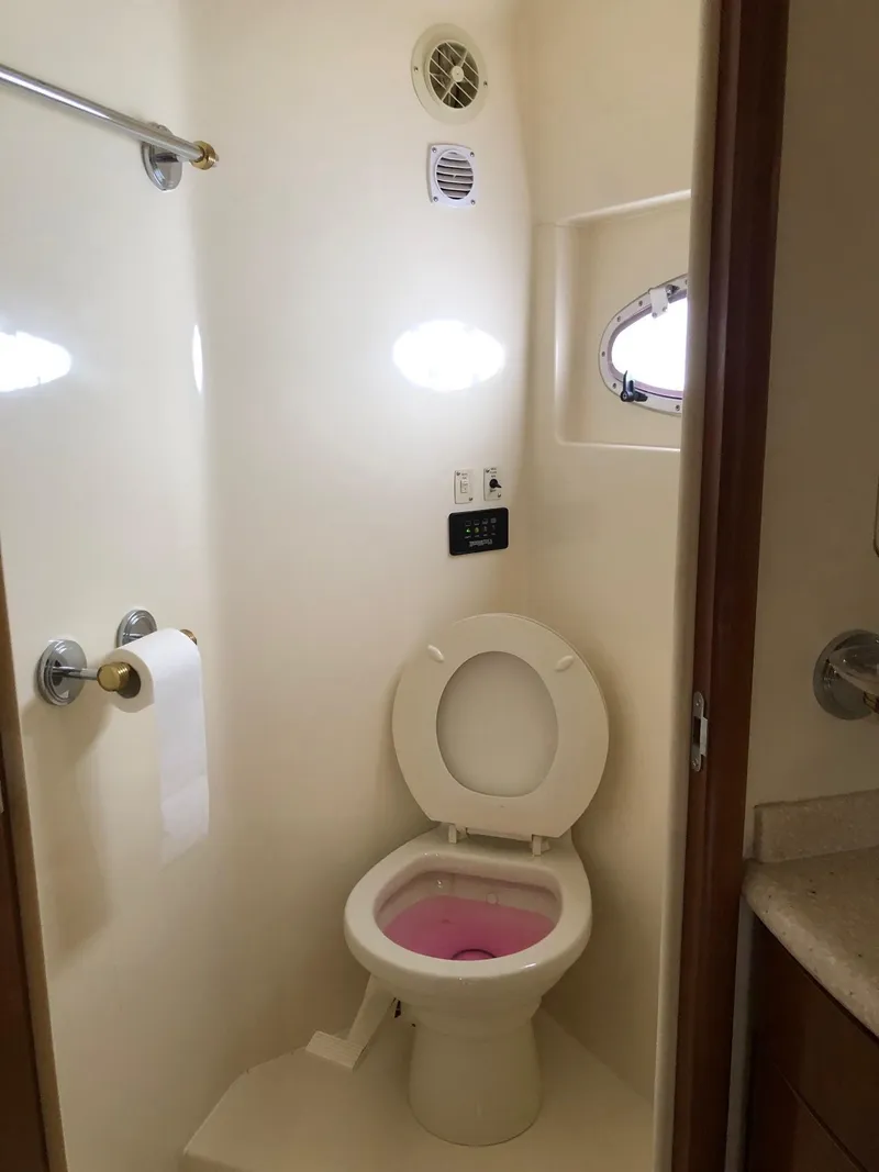 Slide: The Image of Bathroom in 1998 Carver 530 Voyager Pilothouse yacht with toilet and porthole window. - 37